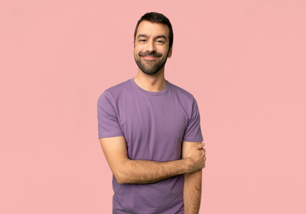 Handsome man With happy expression on isolated pink background