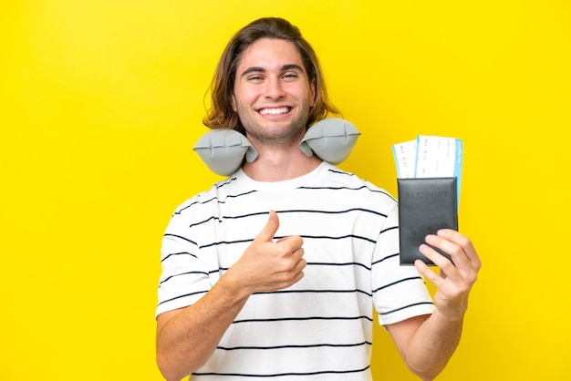 Handsome Man with Inflatable Travel Pillow giving a thumbs up gesture