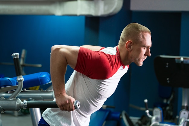 Handsome man working out in fitness gym