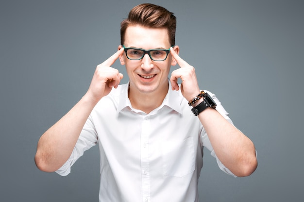 Handsome mature businessman in costly watch, black glasses and white shirt 