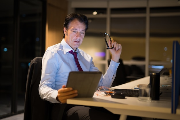 Handsome Mature Businessman Sitting And Working In Office At Night