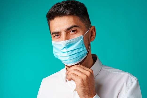 Handsome mixed race man wearing medical face mask