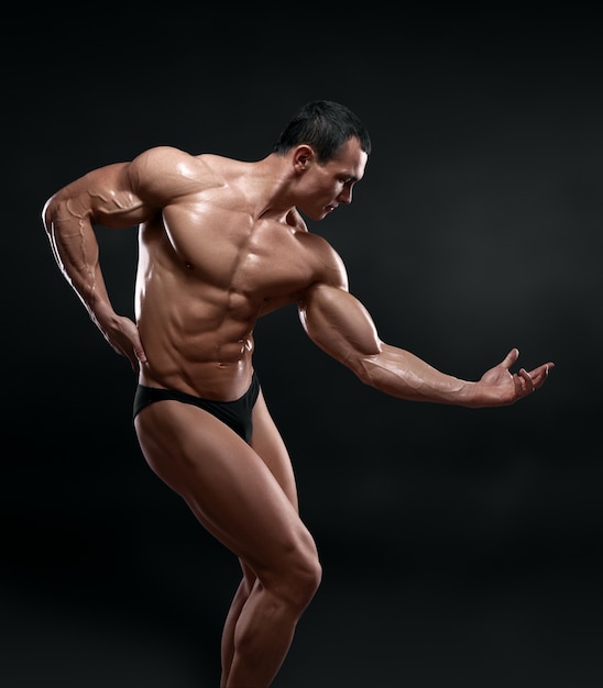 Handsome muscular bodybuilder posing