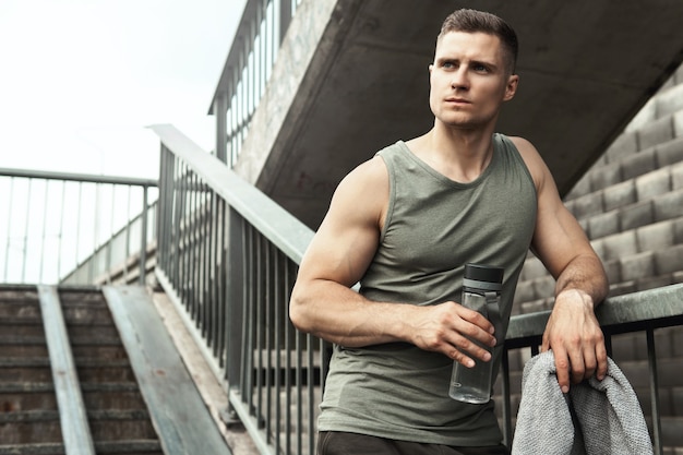 Handsome muscular man after jogging workout on a city street