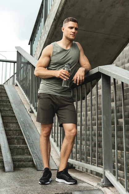 Handsome muscular man after jogging workout on a city street