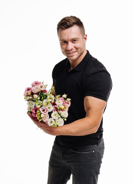 Handsome romantic man with flowers Holiday celebration guy with bouquet