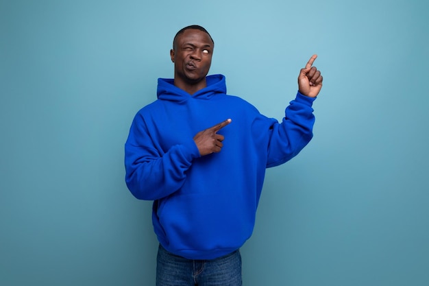 A handsome shorthaired brunette african in a basic hoodie demonstrates the mind and resourcefulness