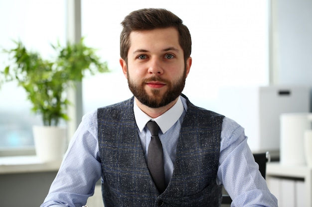 Handsome smiling bearded clerk man at workplace