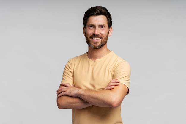 Handsome smiling bearded man looking at camera isolated on grey background