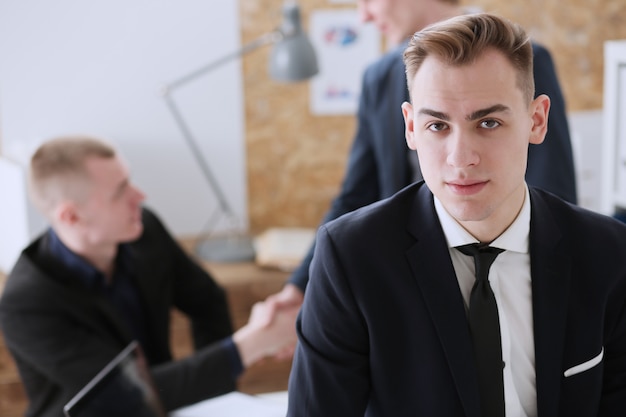 Handsome smiling businessman in suit portrait at workplace