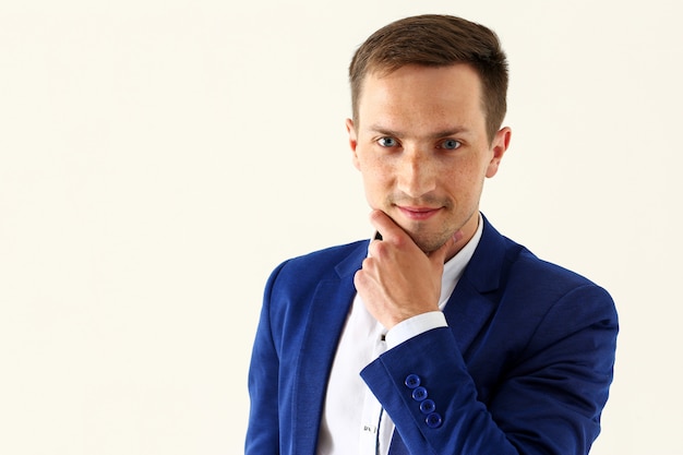 Handsome smiling man in suit looking in camera