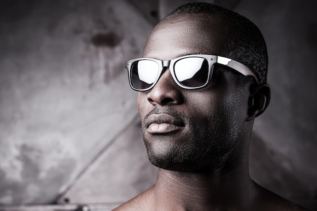 Handsome in sunglasses. Close-up of handsome young shirtless African man in sunglasses