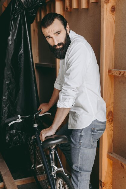 Handsome young bearded man with vintage bicycle