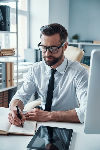 Handsome young businessman working on the desk