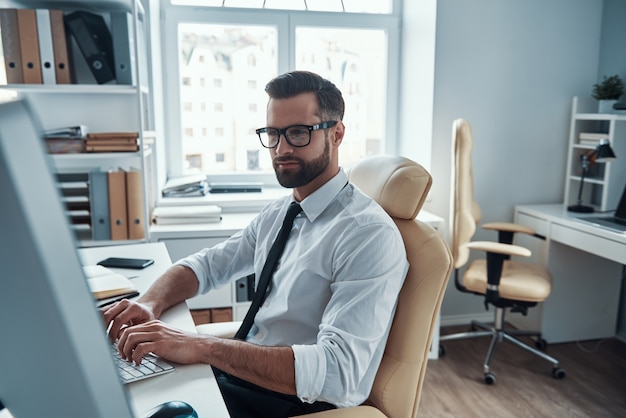 Handsome young businessman working on the desk