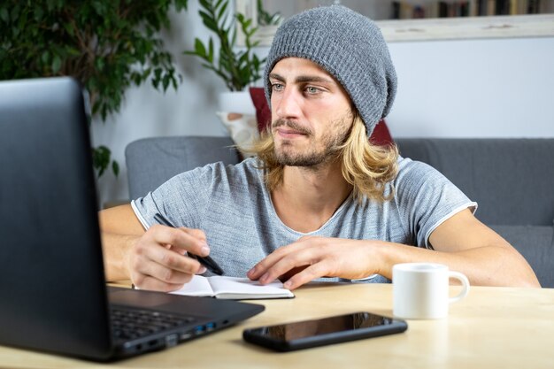 Handsome young caucasian man working at home