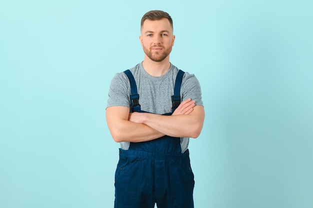 Handsome young craftsman over isolated blue background