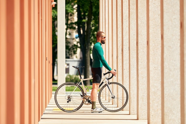 Handsome young cyclist riding a bike in the city