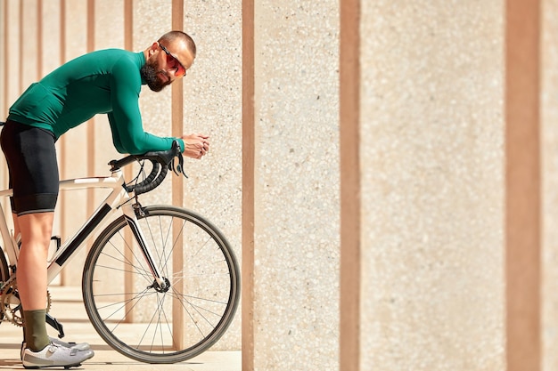 Handsome young cyclist riding a bike in the city