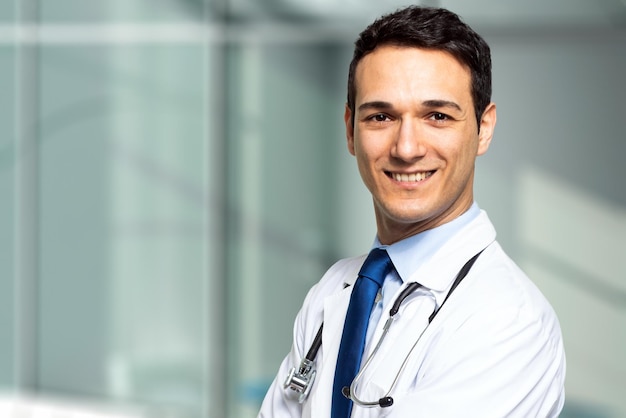 Handsome young doctor portrait in his studio