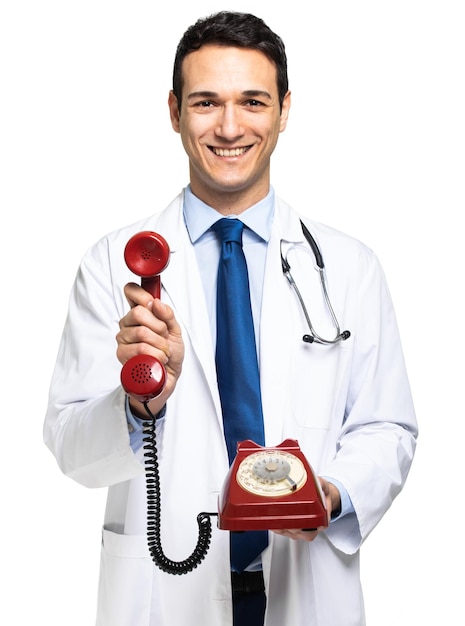 Handsome young doctor portrait holfing a red old fashioned phone