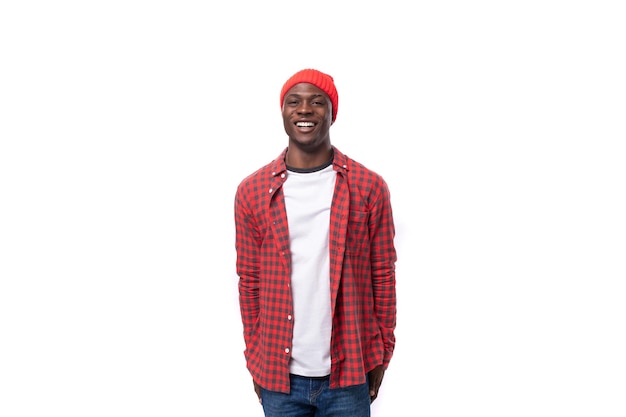 Handsome young ethnic african guy in red plaid shirt isolated on white background