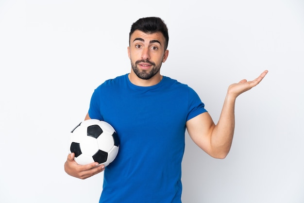 Handsome young football player man over isolated wall extending hands to the side for inviting to come