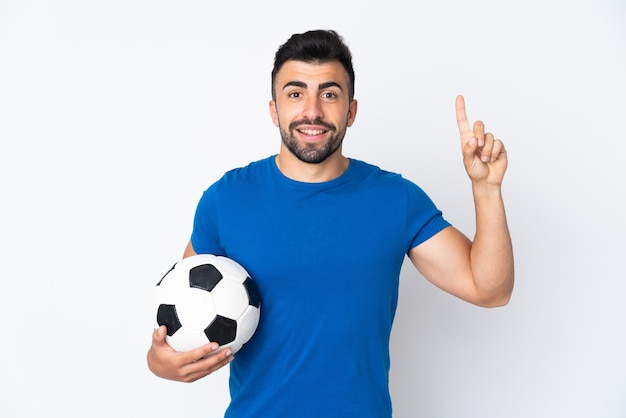 Handsome young football player man over isolated wall pointing up a great idea