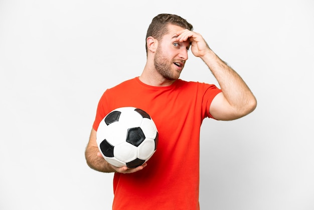 Handsome young football player man over isolated white background doing surprise gesture while looking to the side