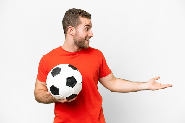 Handsome young football player man over isolated white background with surprise expression while looking side