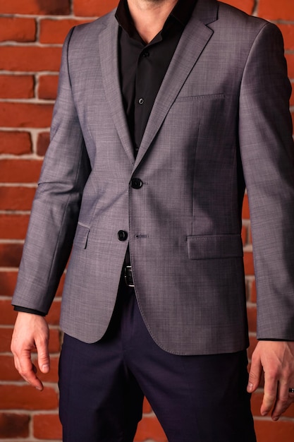 Handsome young handsome businessman in casual gray jacket close up