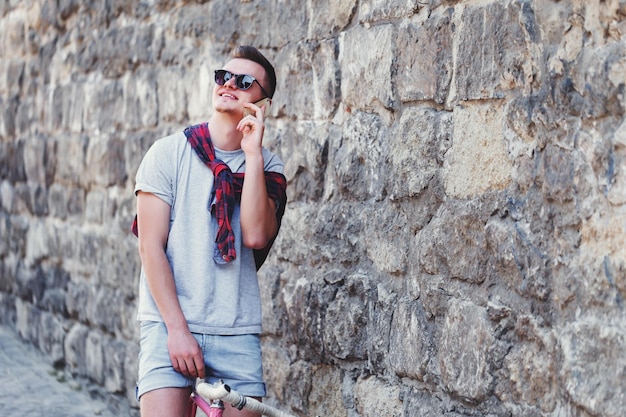 Handsome young hipster man wearing sunglasses