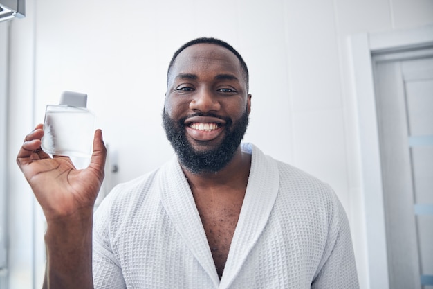 Handsome young international man demonstrating his smile while enjoying his home day