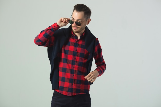 handsome young male in plaid shirt in sunglasses