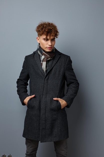 Handsome young man Black coat posing fashion isolated background