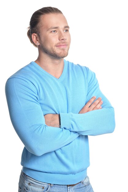 Handsome young man in blue sweater isolated on white background