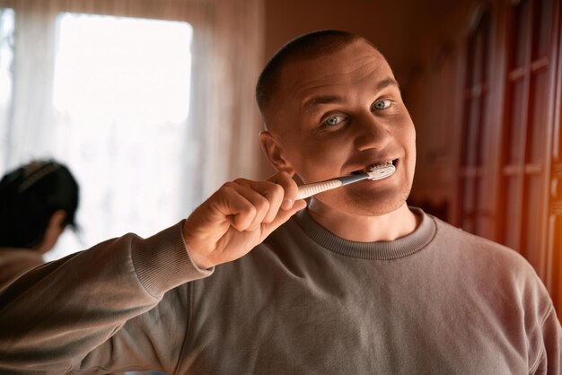 Handsome young man brushing his teeth Oral care concept