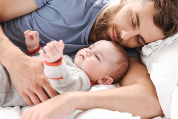 Handsome young man father dad sleeping in bed