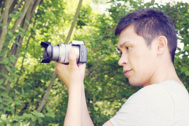 A handsome young man holding a camera