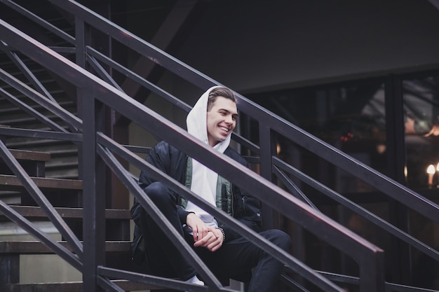 Handsome young man in jacket with hoodie