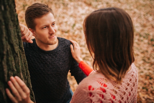 Handsome young man look at woman and smile