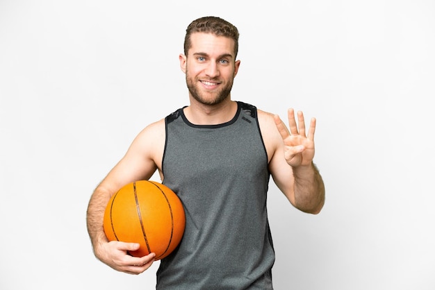 Handsome young man playing basketball over isolated white background happy and counting four with fingers