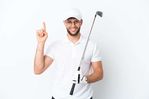 Handsome young man playing golf isolated on white background pointing up a great idea