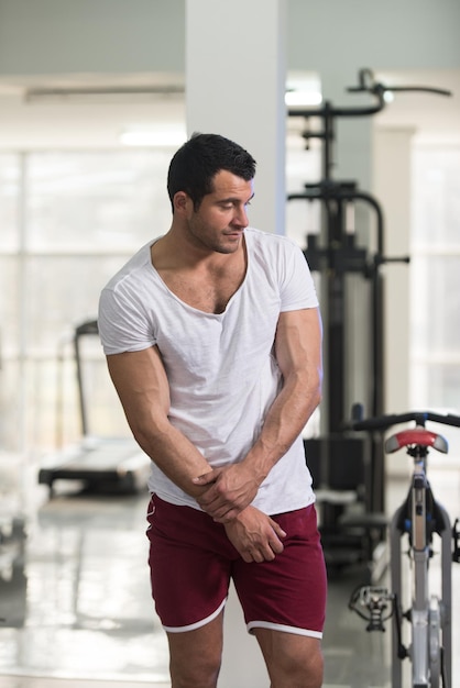 Handsome Young Man Standing Strong in White Tshirt and Flexing Muscles  Muscular Athletic Bodybuilder Fitness Model Posing After Exercises