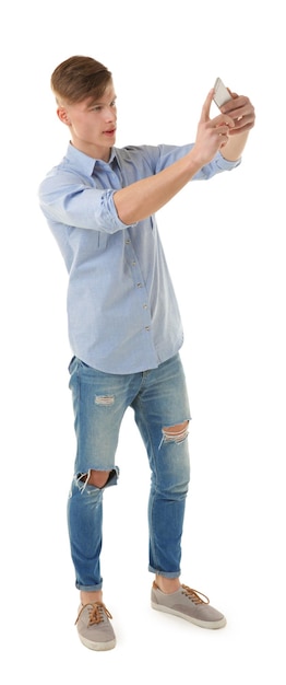 Handsome young man taking selfie on white background