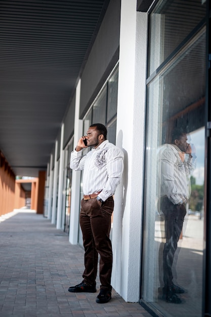 Handsome young man talking with phone outdoor Business communication