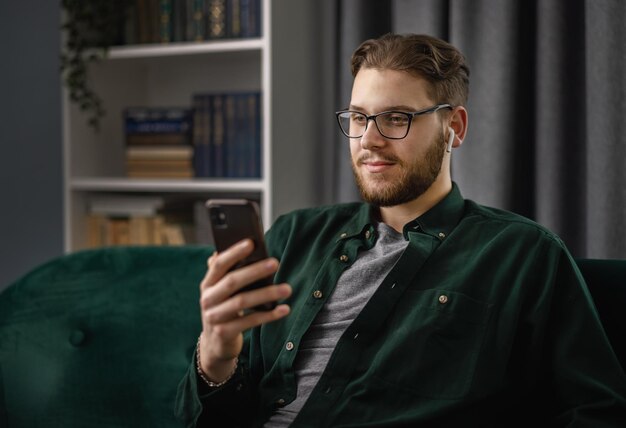 Handsome young man using smartphone while