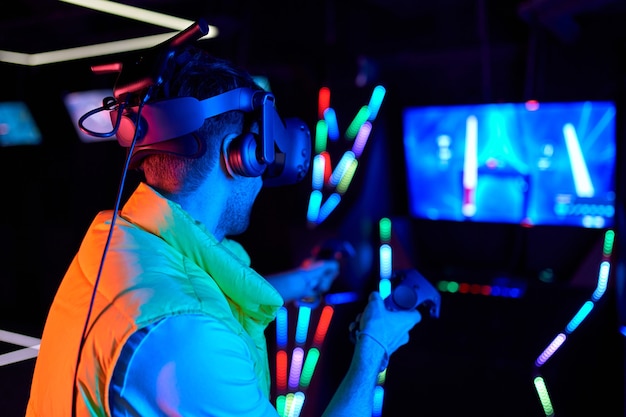 Handsome young man with glasses of virtual reality. VR, games, entertainment, future technology concept.