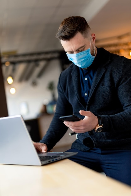 Handsome young man working in corona time with mask Quarantine protection lifestyle