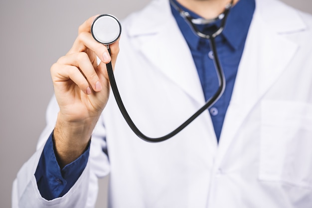 Handsome young medic doctor holding a stethoscope,